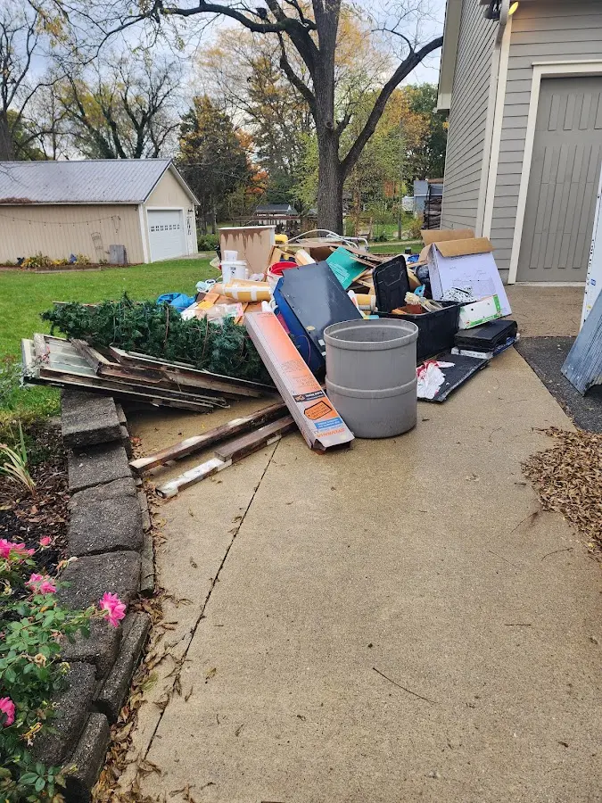 Dumpster being loaded with debris for Demolition Dumpster Rental in Sugar Hill